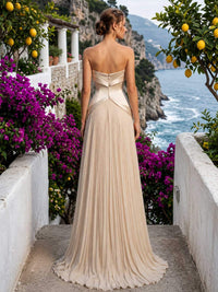 Champagne chiffon mother of the bride dress back view with strapless bodice, concealed back zipper, structured waist panel, and pleated floor length skirt