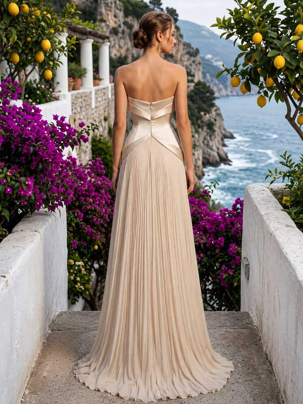 Champagne chiffon mother of the bride dress back view with strapless bodice, concealed back zipper, structured waist panel, and pleated floor length skirt