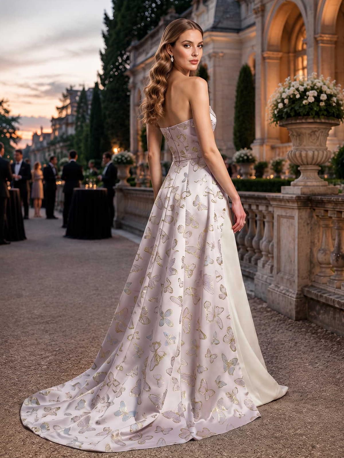 Butterfly jacquard satin mother of the bride dress back view with strapless bodice, concealed back zipper, fitted waist, flowing overskirt, sweep train, and floor length skirt