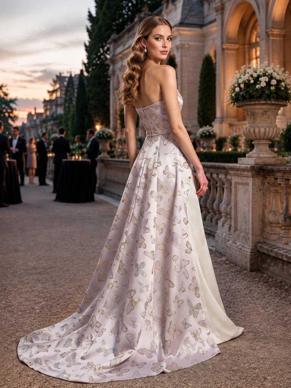Butterfly jacquard satin mother of the bride dress back view with strapless bodice, concealed back zipper, fitted waist, flowing overskirt, sweep train, and floor length skirt