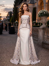 Butterfly jacquard satin mother of the bride dress front view with strapless neckline, fitted bodice, bow waist accent, satin sheath skirt, overskirt panels, and floor length silhouette