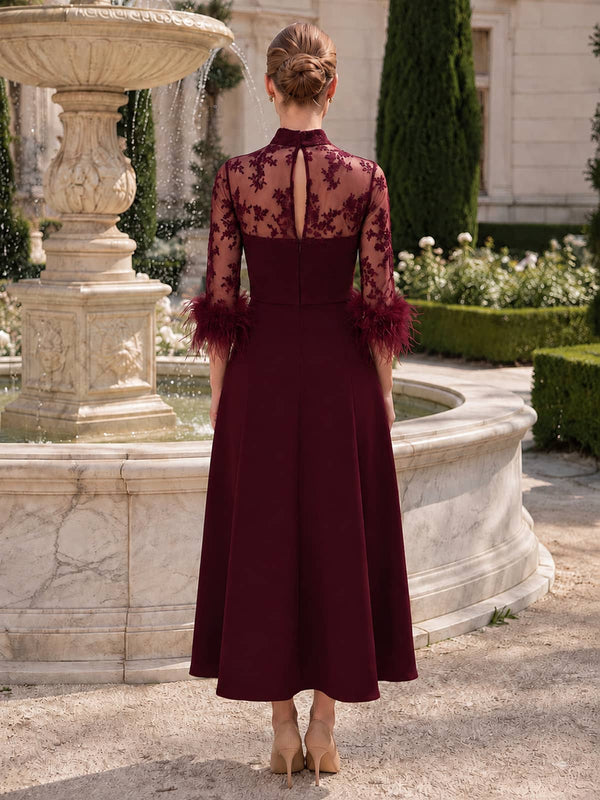 Burgundy chiffon mother of the bride dress back view with sheer lace high neck, keyhole back detail, concealed zipper, feather cuff sleeves, and tea length A-line skirt