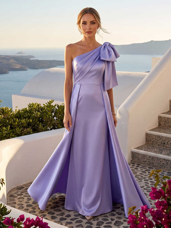 Lavender faux silk mother of the bride dress front view with one shoulder neckline, bow shoulder detail, draped bodice, and floor length A-line silhouette