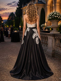 Mother of the bride satin evening dress back view with strapless back, contrast bodice, floral appliqué placement, concealed zipper, and floor length A-line skirt
