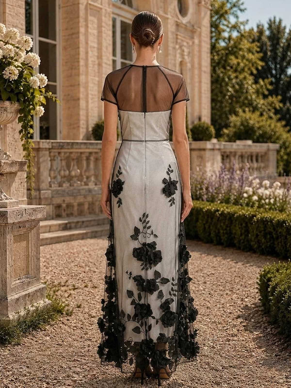Floral tulle mother of the bride dress back view with sheer black illusion upper back, short sleeves, black floral lace overlay, concealed back zipper, and floor length skirt