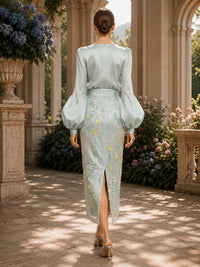 Mother of the bride floral faux silk dress back view with long bishop sleeves, concealed zipper, embroidered lace skirt, and back slit