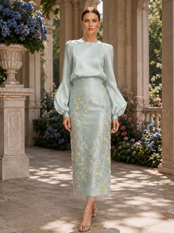 Mother of the bride floral faux silk dress front view with jewel neckline, long bishop sleeves, and embroidered lace midi skirt