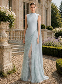 Ice blue satin mother of the bride dress front view with sleeveless high neckline, asymmetrical pleated tulle overlay, floral appliqué details, front slit, and floor length silhouette