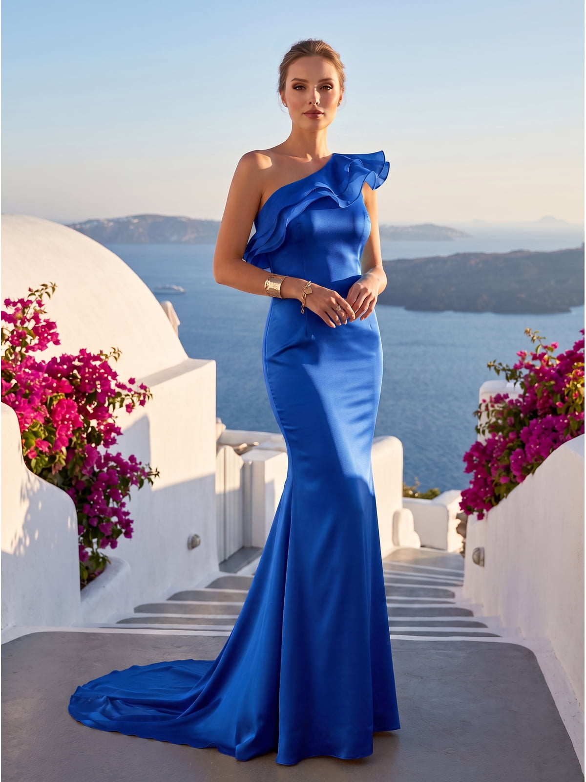 Front view of a royal blue satin floor-length mother of the bride dress with asymmetric one-shoulder neckline, layered organza ruffles across the shoulder and bodice, fitted waist, sculpted mermaid silhouette, and elegant sweep train.