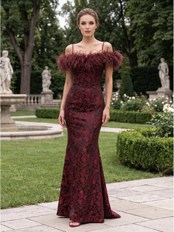 Front view of a burgundy and dark floral jacquard satin floor-length mother of the bride dress with off-the-shoulder feather trim, delicate spaghetti straps, fitted bodice, sculpted waist, and elegant mermaid silhouette.