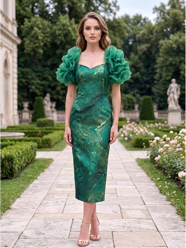 Front view of a jacquard satin midi mother of the bride dress with sweetheart neckline, dramatic layered organza ruffle sleeves, fitted structured bodice, defined waist, artistic green and gold jacquard pattern, and elegant sheath skirt.