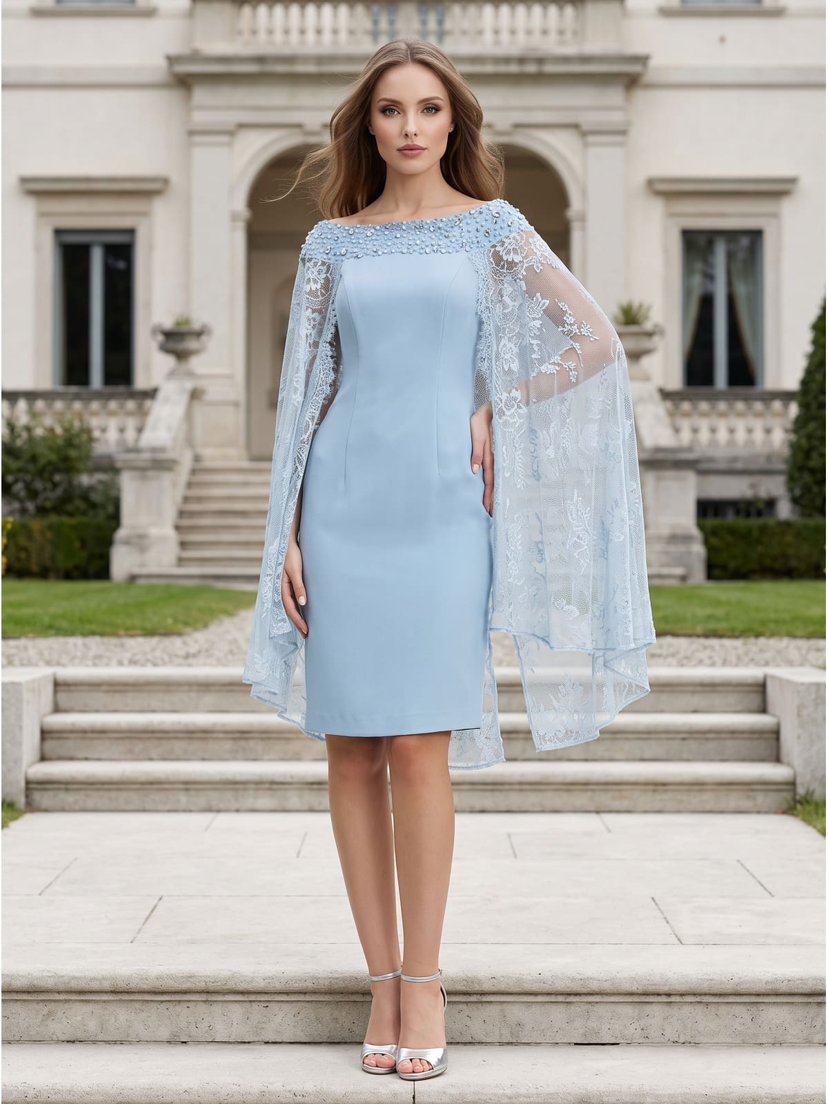 Front view of a light blue chiffon knee-length mother of the bride dress with bateau neckline, fitted sheath silhouette, sheer floral lace cape overlay, beaded neckline embellishment, and elegant straight skirt.