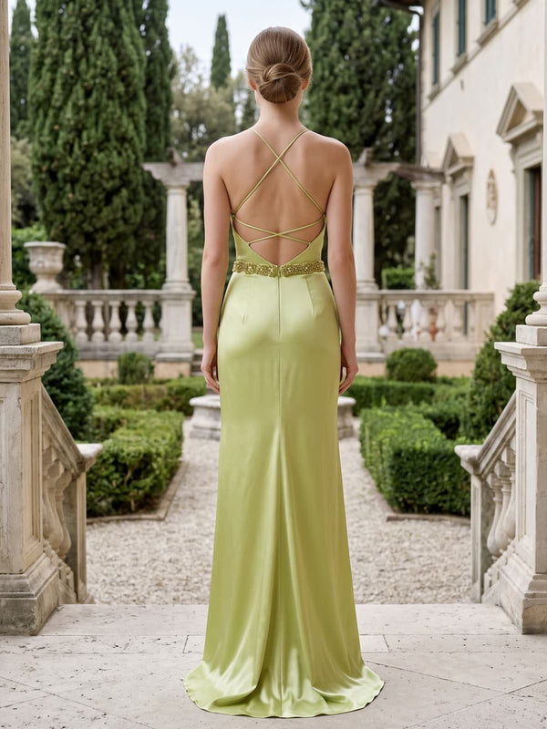 Back view of a light green satin floor-length mother of the bride dress with open back, delicate crisscross straps, beaded waist detail, center-back zipper, and softly flowing column skirt.