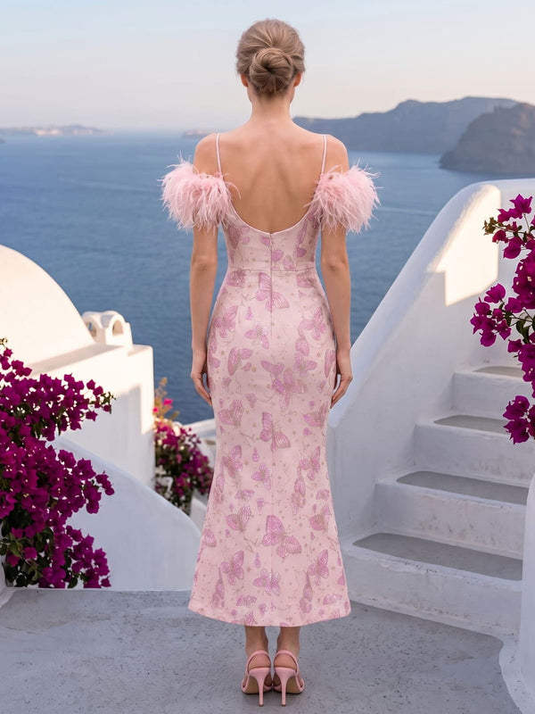 Back view of a pink butterfly jacquard satin ankle-length mother of the bride dress with slim spaghetti straps, a low scoop back, fitted sheath silhouette, center-back zipper, and soft feather trim around the shoulders.