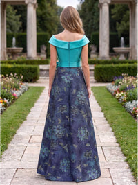 Back view of a mother of the bride dress featuring a turquoise satin off-the-shoulder back neckline, defined waistband, clean center-back zipper, and a floor-length A-line jacquard satin skirt with a dark floral-inspired pattern.