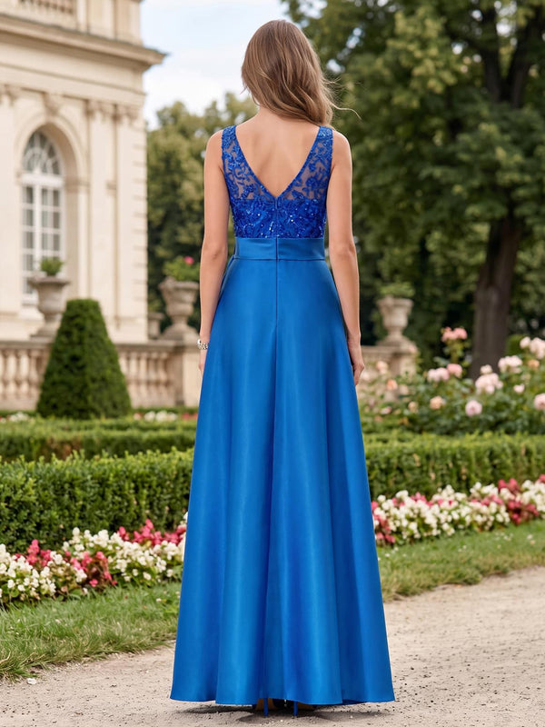 Back view of a floor-length mother of the bride dress featuring a deep V-shaped floral lace and sequin back bodice, sleeveless construction, wide imitation silk waistband, center-back zipper, and a flowing A-line imitation silk skirt.