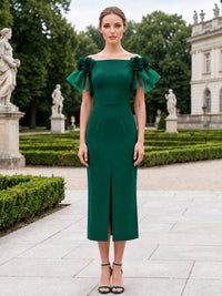 Front view of a tea-length mother of the bride dress featuring a satin sheath silhouette, an off-the-shoulder neckline, floral shoulder accents, soft organza flutter sleeves, and a subtle front slit.
