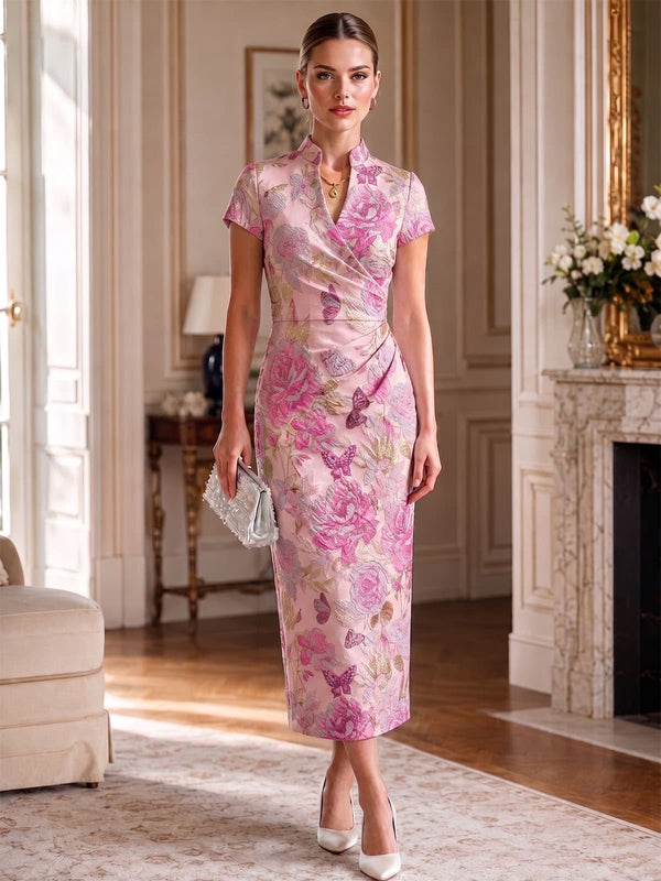 Front view of an as pic color floral jacquard satin tea length mother of the bride dress with mandarin collar, short sleeves, wrap detail, and sheath silhouette.