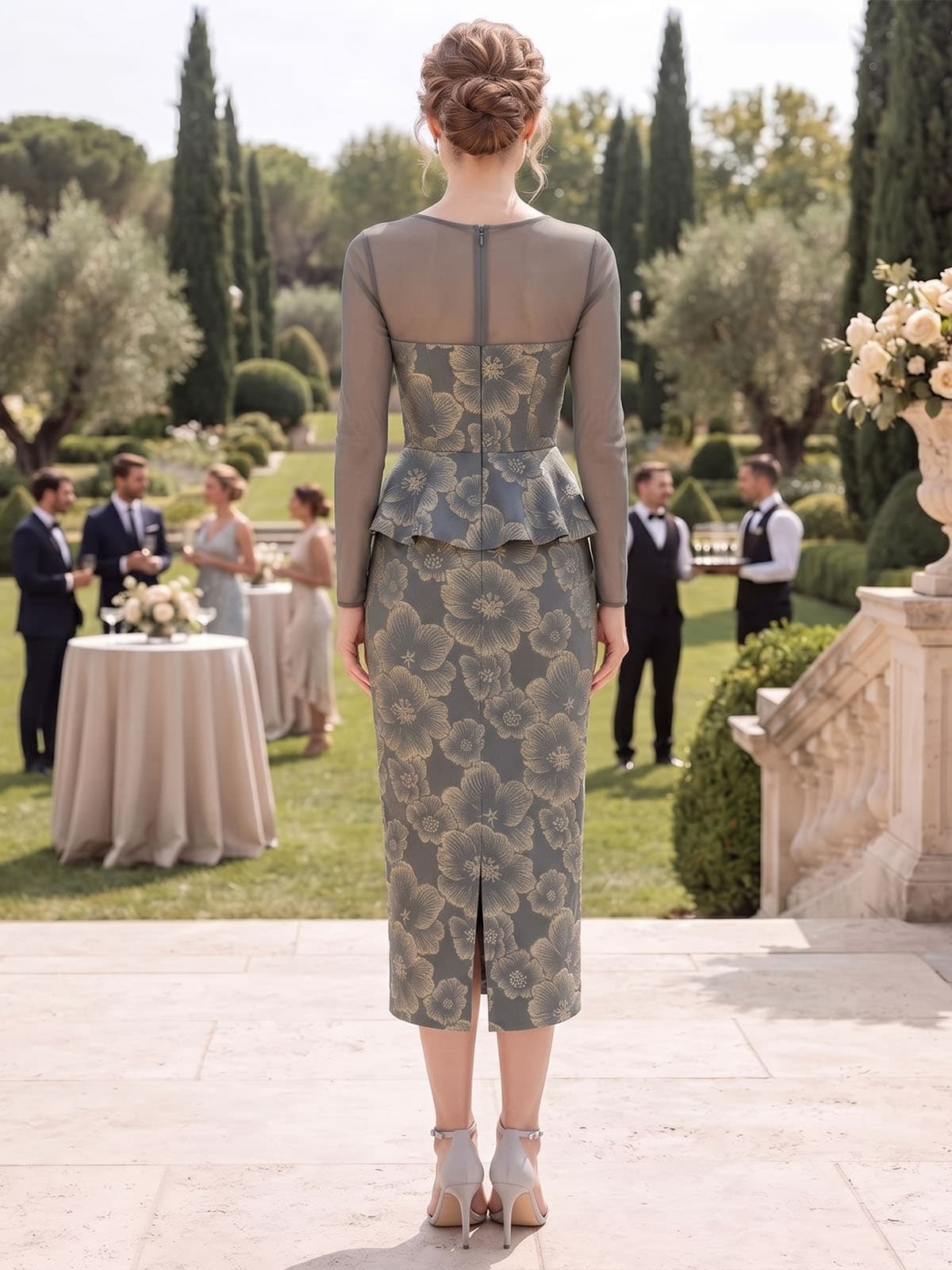 Back view of an as pic color floral jacquard satin tea length mother of the bride dress with concealed back zipper, sheer long sleeves, floral jacquard texture, peplum waist, and fitted skirt.