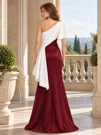Back view of a burgundy satin mother of the bride dress with an asymmetric ivory draped overlay, one-shoulder design, concealed back zipper and floor length sheath silhouette.