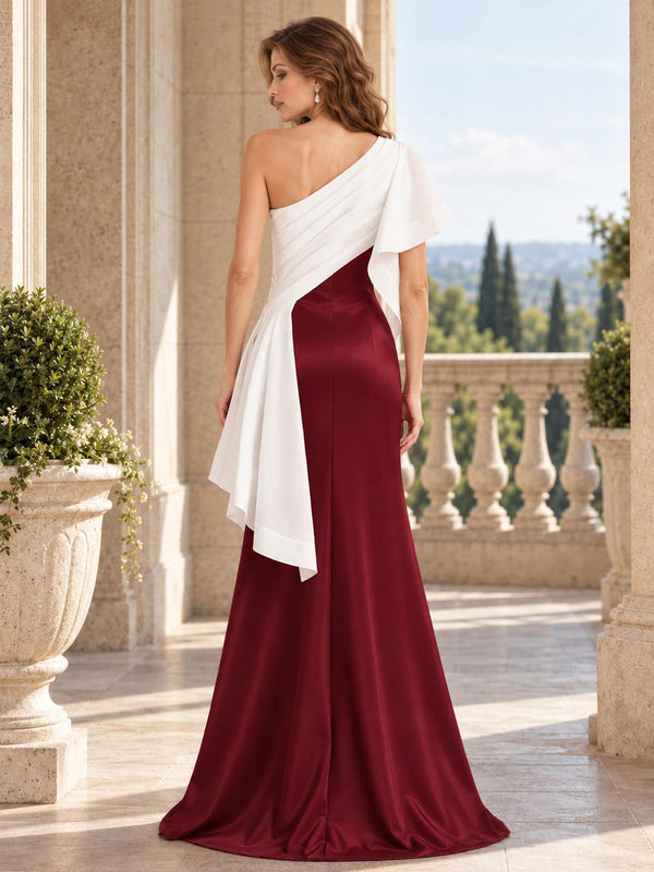 Back view of a burgundy satin mother of the bride dress with an asymmetric ivory draped overlay, one-shoulder design, concealed back zipper and floor length sheath silhouette.