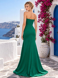 Back view of an emerald green satin mother of the bride dress with strapless straight back, concealed center back zipper, fitted silhouette and floor length flared hem.