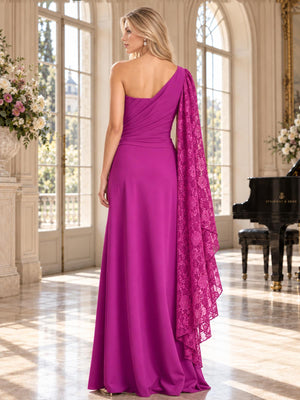 Back view of an elegant chiffon mother of the bride dress featuring an asymmetric one-shoulder back, ruched fitted waist, flowing floor-length A-line skirt and a long cascading floral lace cape draped elegantly from the shoulder.