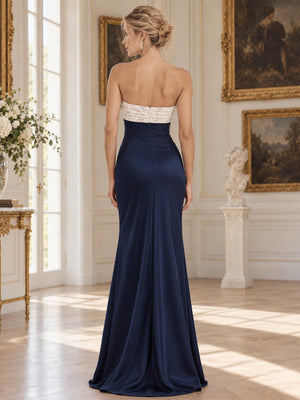 Back view of an elegant satin and floral lace mother of the bride dress featuring a strapless-style straight back with contrasting floral lace trim, fitted sheath silhouette, concealed center-back zipper and floor-length satin skirt.