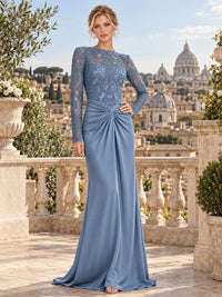 Front view of an elegant lace and satin mother of the bride dress featuring a jewel neckline, intricate floral lace bodice, sheer long lace sleeves, ruched knot waist and a draped floor-length sheath skirt.