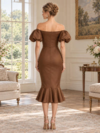 Back view of an elegant satin mother of the bride dress featuring a straight off-shoulder back neckline, short puff sleeves, fitted waist, concealed center-back zipper and a flounced midi mermaid hem.