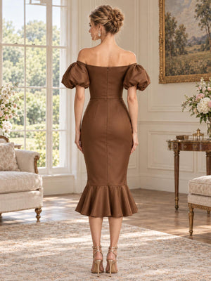 Back view of an elegant satin mother of the bride dress featuring a straight off-shoulder back neckline, short puff sleeves, fitted waist, concealed center-back zipper and a flounced midi mermaid hem.