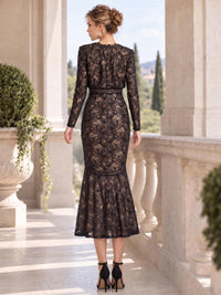 Back view of an elegant floral lace mother of the bride dress featuring sheer long lace sleeves, all-over floral lace, defined waist paneling, fitted mermaid silhouette and softly flared midi hem over a contrasting nude-tone lining.