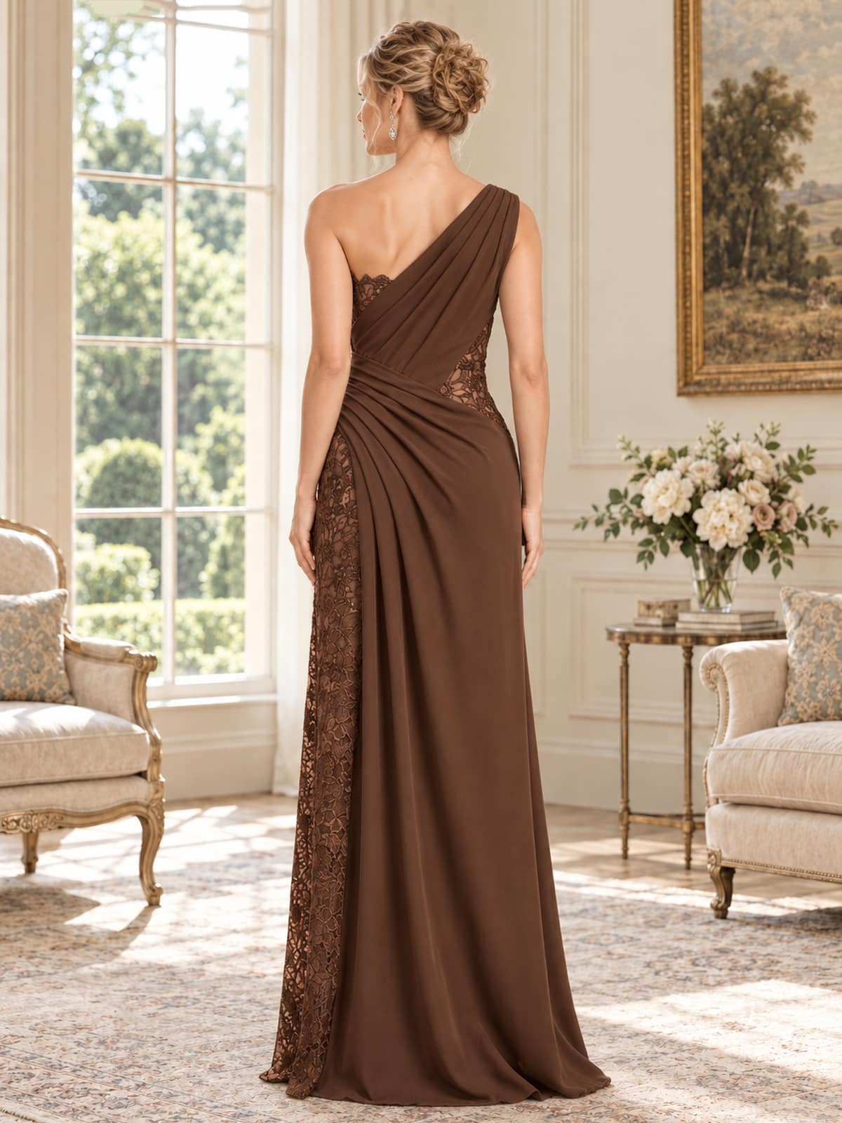 Back view of an elegant chiffon and floral lace mother of the bride dress featuring an asymmetrical one-shoulder design, diagonal pleated chiffon draping, floral lace side paneling, fitted waist and flowing floor-length skirt.