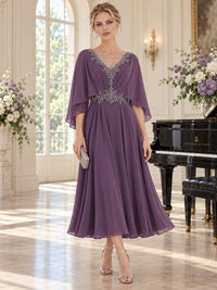 Front view of an elegant chiffon mother of the bride dress featuring a V-neckline with sheer illusion inset, intricate beaded neckline and waist embellishments, flowing cape sleeves, softly gathered bodice and tea-length A-line skirt in a muted purple tone.