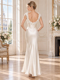 Back view of an elegant ivory faux silk mother of the bride dress featuring a deep scoop back surrounded by dimensional 3D floral appliqués, delicate bead accents, concealed center-back zipper and a smooth floor-length sheath skirt.