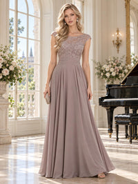 Front view of a taupe lace and chiffon mother of the bride dress featuring a floral lace bodice, bateau neckline, cap sleeves, softly pleated waist and flowing floor-length A-line chiffon skirt.