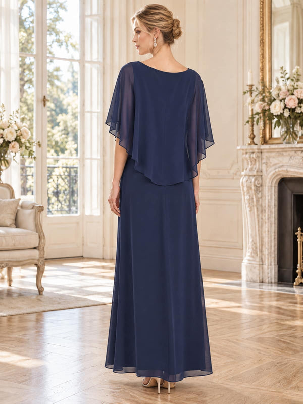 Back view of a navy chiffon mother of the bride dress featuring a softly draped layered cape overlay, jewel back neckline and flowing floor-length A-line chiffon skirt.