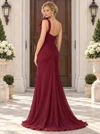 Back view of a burgundy chiffon mother of the bride dress featuring an asymmetric one-shoulder back, ruched waist detail, concealed center-back zipper and flowing floor-length chiffon skirt.