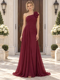 Front view of a burgundy chiffon mother of the bride dress featuring an asymmetric one-shoulder neckline, statement 3D floral shoulder embellishment, diagonally ruched bodice, draped waist and flowing floor-length A-line skirt.