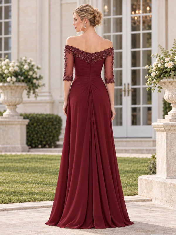 Back view of a burgundy chiffon and floral lace mother of the bride dress featuring an off-the-shoulder floral lace neckline, sheer beaded lace sleeves, ruched waist, concealed center-back zipper and flowing floor-length skirt.
