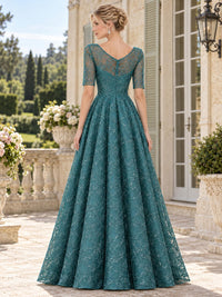 Back view of a teal floral lace mother of the bride dress featuring a soft V-back, sheer floral lace upper bodice and sleeves, defined waist, concealed center-back zipper and full floor-length A-line skirt.