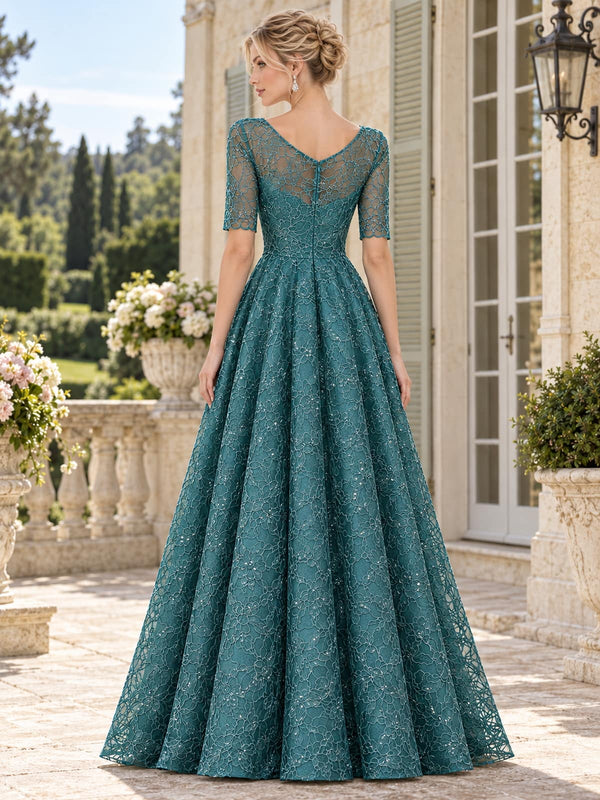 Back view of a teal floral lace mother of the bride dress featuring a soft V-back, sheer floral lace upper bodice and sleeves, defined waist, concealed center-back zipper and full floor-length A-line skirt.