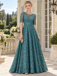 Front view of a teal floral lace mother of the bride dress featuring a bateau neckline, sheer floral lace upper bodice, elbow-length lace sleeves, fitted natural waist and full floor-length A-line skirt with allover floral lace.