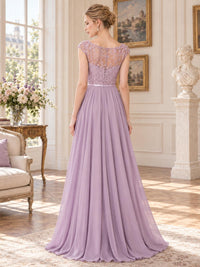 Back view of a dusty lavender lace and chiffon mother of the bride dress featuring a sheer floral lace illusion back, cap sleeves, slim satin waistband, concealed center-back zipper and flowing floor-length chiffon skirt.