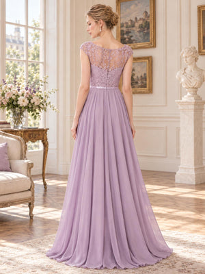 Back view of a dusty lavender lace and chiffon mother of the bride dress featuring a sheer floral lace illusion back, cap sleeves, slim satin waistband, concealed center-back zipper and flowing floor-length chiffon skirt.