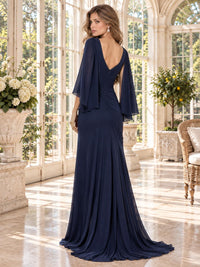 Back view of a navy blue chiffon mother of the bride dress featuring a V-shaped back neckline, flowing cape sleeves, gathered center-back detailing and an elegant floor-length sheath skirt.
