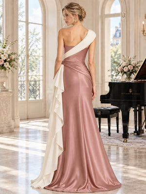 Back view of a dusty rose and ivory two-tone satin mother of the bride dress featuring an asymmetric ivory shoulder drape crossing the back, ruched waist, cascading contrast side panel and floor-length sheath silhouette.