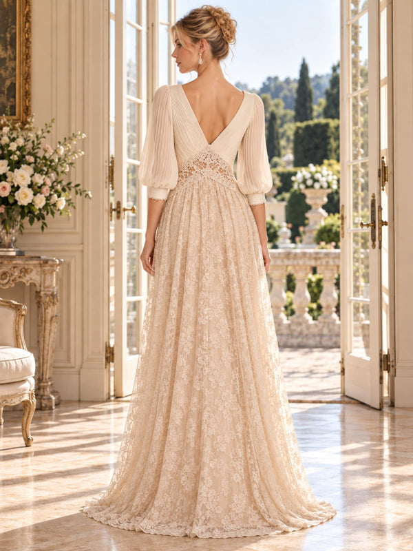 Back view of an ivory and champagne floral lace chiffon mother of the bride dress featuring a deep V-back, three-quarter bishop sleeves, lace waist inset and an all-over floral lace floor-length A-line skirt.