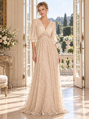 Front view of an ivory and champagne floral lace chiffon mother of the bride dress featuring a pleated V-neck bodice, three-quarter bishop sleeves, intricate lace waist inset and an all-over floral lace floor-length A-line skirt.