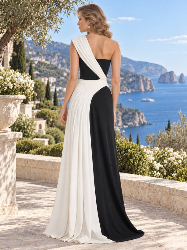 Back view of a black and ivory two-tone satin mother of the bride dress featuring an asymmetric ivory shoulder drape crossing diagonally into the waist, contrasting ivory skirt panel and floor-length sheath silhouette.